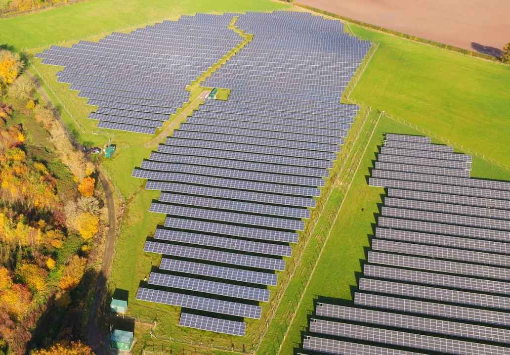 Aerial image of rows of solar panels in field near Sheriffhales